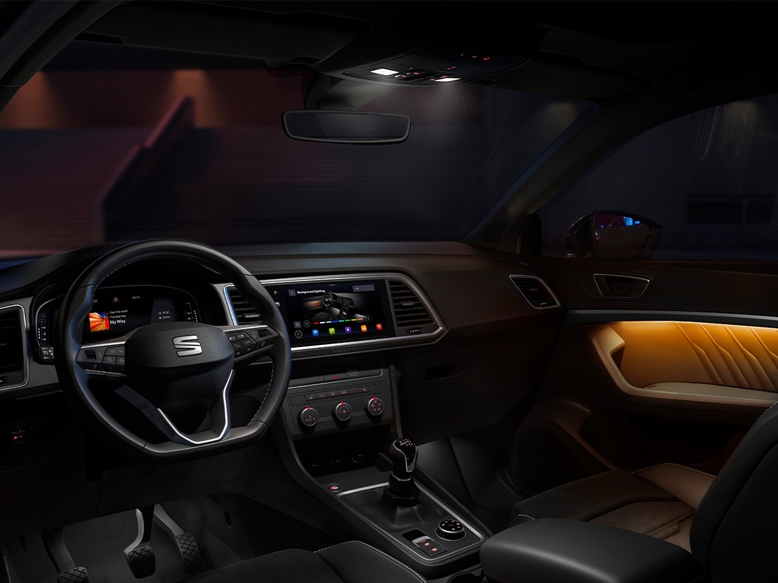 Innenraum des SEAT Ateca mit eingeschalteter Ambientebeleuchtung an den Türverkleidungen