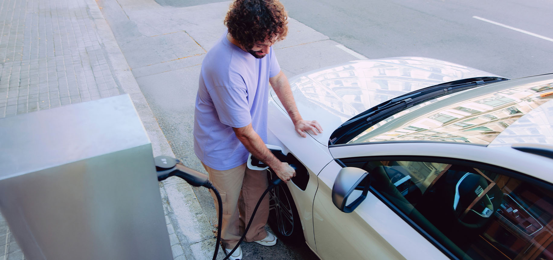 red seat leon parked against a modern urban background, showcasing fuel economy and low emissions for environmentally conscious drivers.